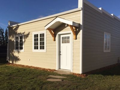 <div class='capText'>Unique details like a flat roof, false front, and timber detail over door make this job one of a kind.</div>